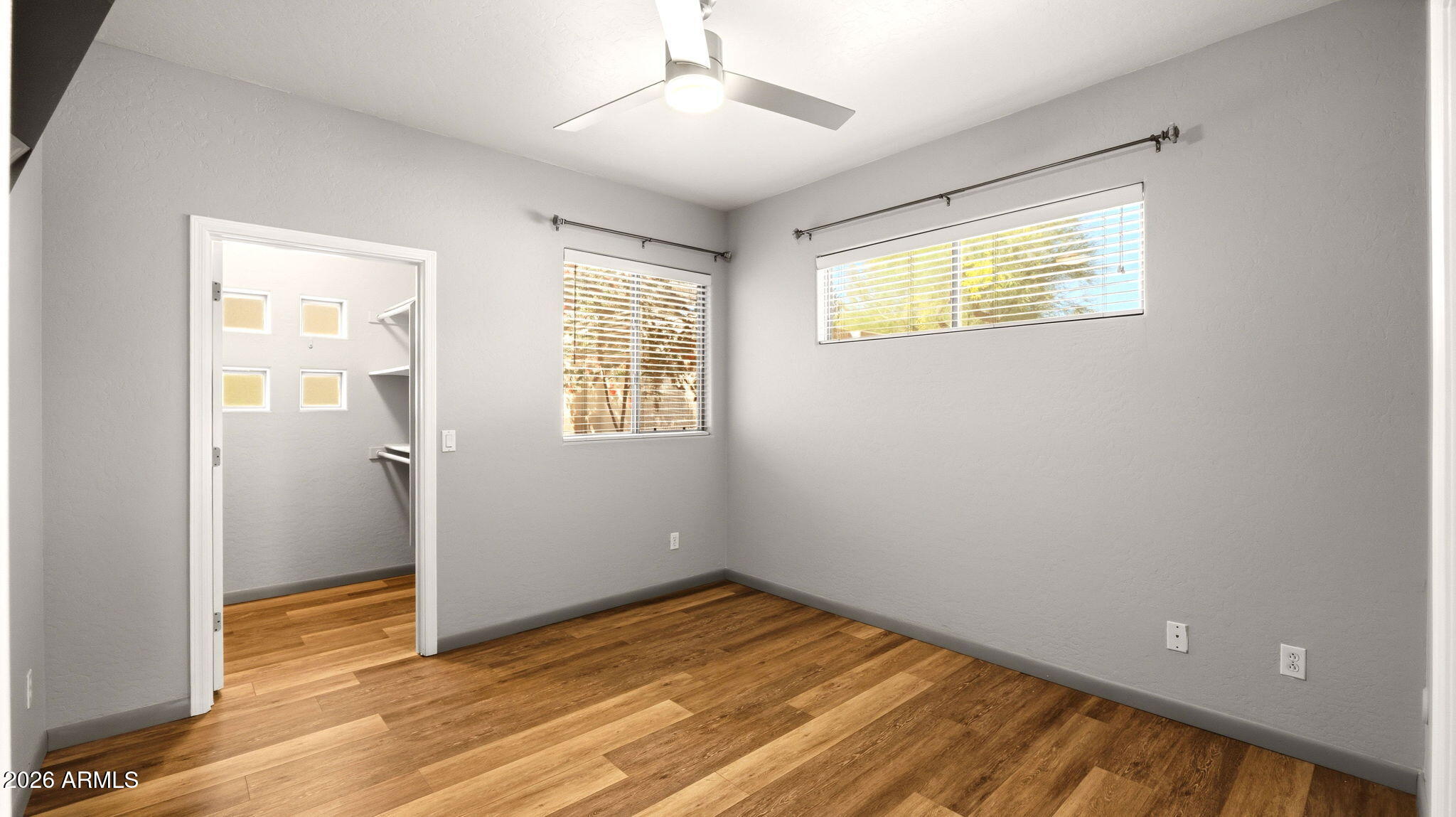9065 East Gary Road, Unit 126 Scottsdale, AZ 85260 - Photo 24 of 37 a view of an empty room with wooden floor and a window