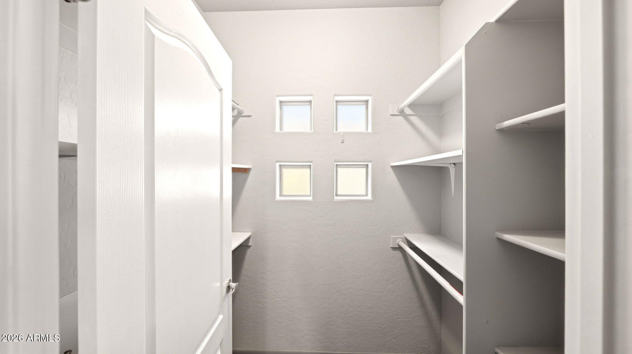 9065 East Gary Road, Unit 126 Scottsdale, AZ 85260 - Photo 25 of 37 a view of a hallway with windows