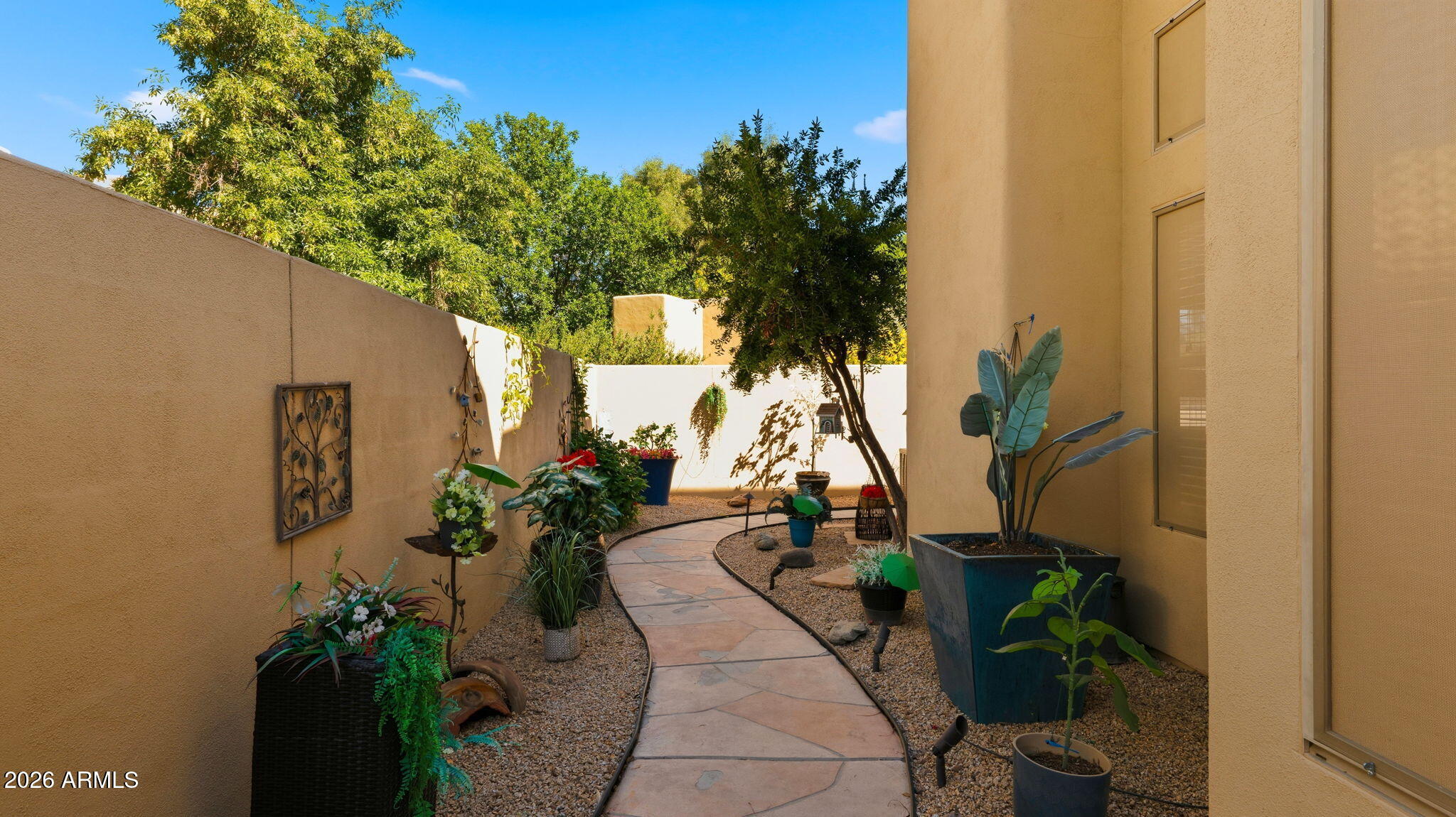 9065 East Gary Road, Unit 126 Scottsdale, AZ 85260 - Photo 28 of 37 a potted plant sitting in front of a house