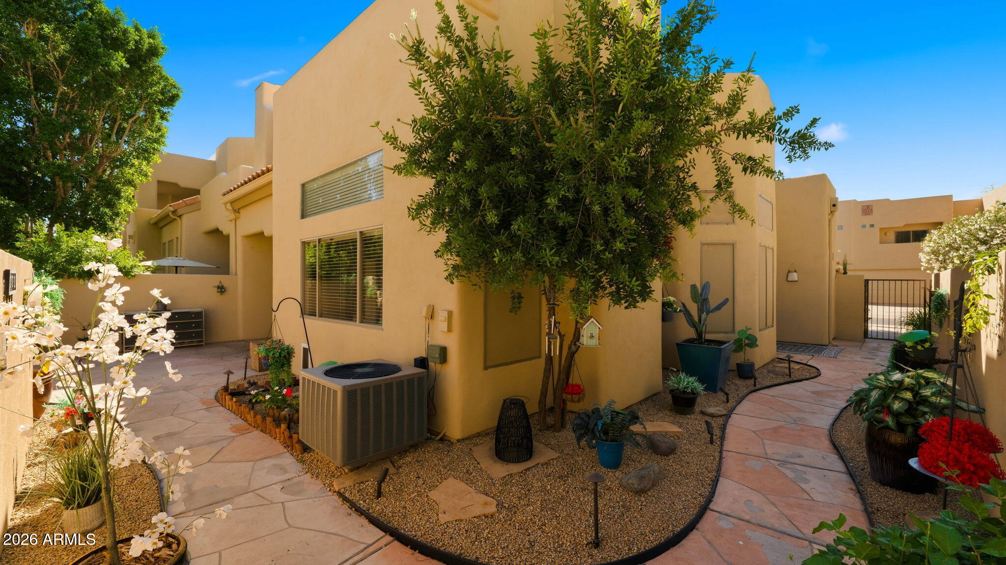 9065 East Gary Road, Unit 126 Scottsdale, AZ 85260 - Photo 33 of 37 a view of a patio with table and chairs potted plants