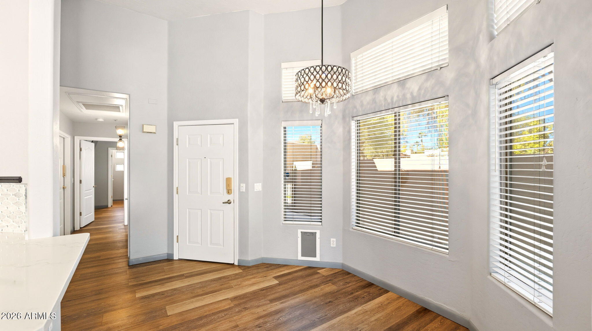 9065 East Gary Road, Unit 126 Scottsdale, AZ 85260 - Photo 9 of 37 a view of a livingroom with a chandelier fan and windows