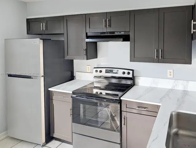 a kitchen with a stove and a refrigerator