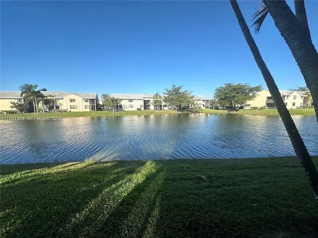 a view of a lake with houses in the back