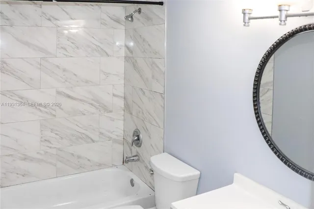 a bathroom with a toilet and a tub