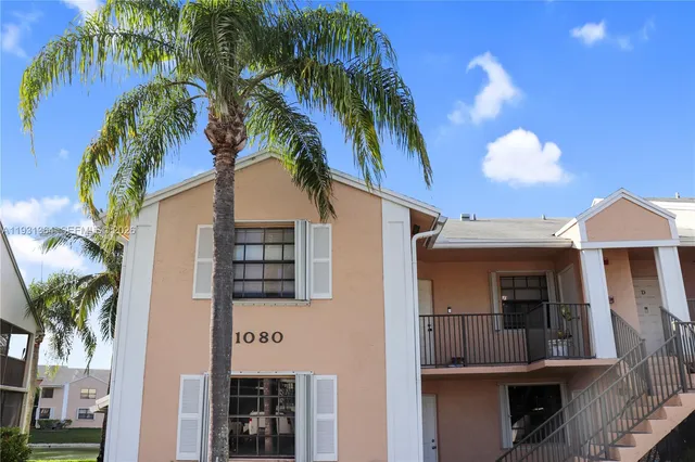 a view of a house with a palm tree