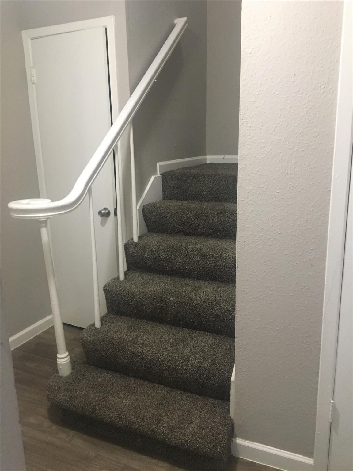 6200 West Tidwell Road, Unit 2102 Houston, TX 77092 - Photo 9 of 14 a living room with furniture and stairs