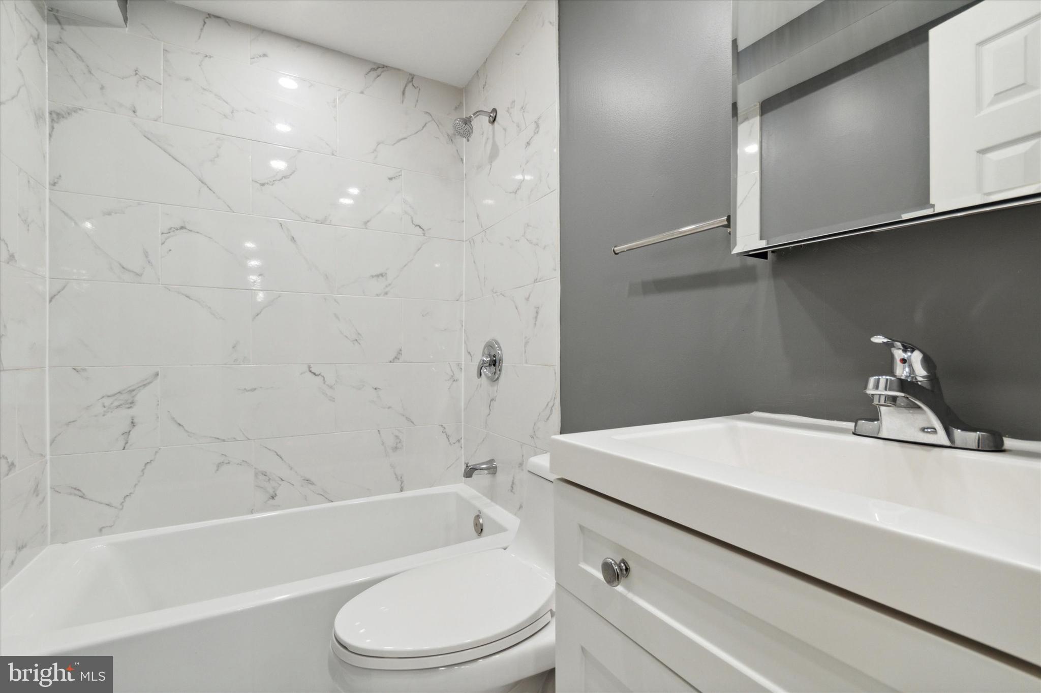 37 Walnut Street, Unit STUDIO Morton, PA 19070 - Photo 7 of 8 a bathroom with a sink a toilet and a bathtub