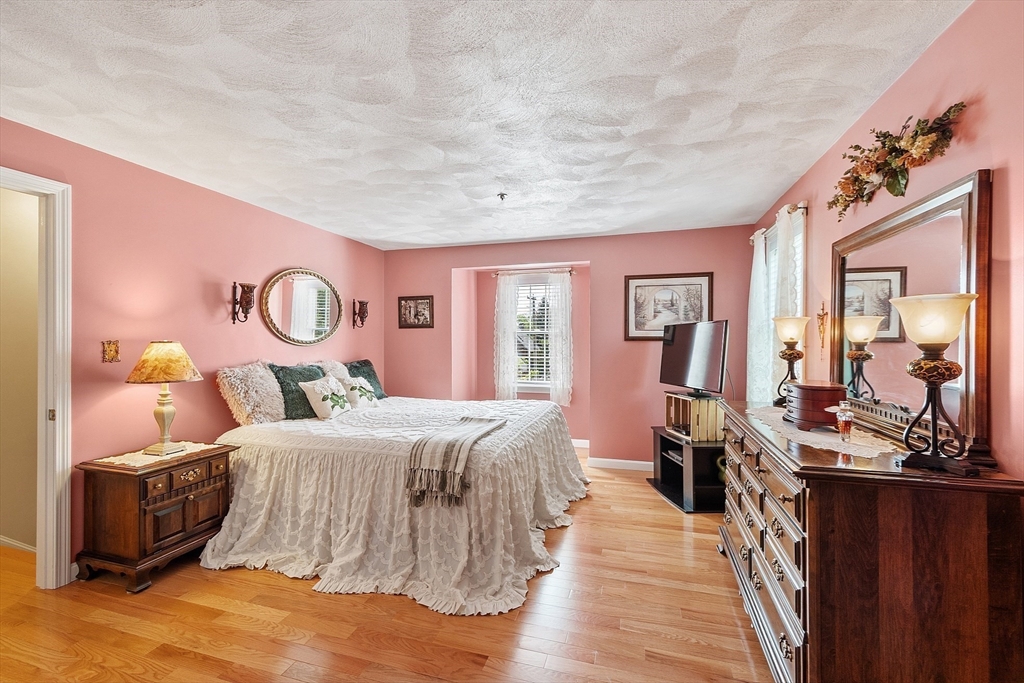 2 Oak Hill Road Haverhill, MA 01830 - Photo 26 of 42 a bedroom with a large bed and a large mirror on the dresser