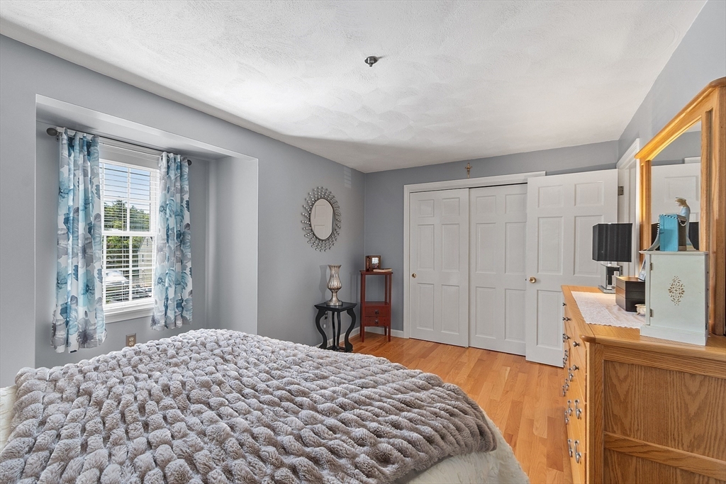 2 Oak Hill Road Haverhill, MA 01830 - Photo 29 of 42 a bedroom with a bed and a dresser with wooden floor