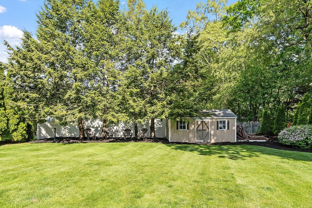 2 Oak Hill Road Haverhill, MA 01830 - Photo 40 of 42 a backyard of a house with lots of plants and tree