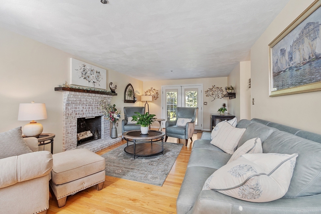 2 Oak Hill Road Haverhill, MA 01830 - Photo 6 of 42 a living room with furniture a fireplace and a large mirror