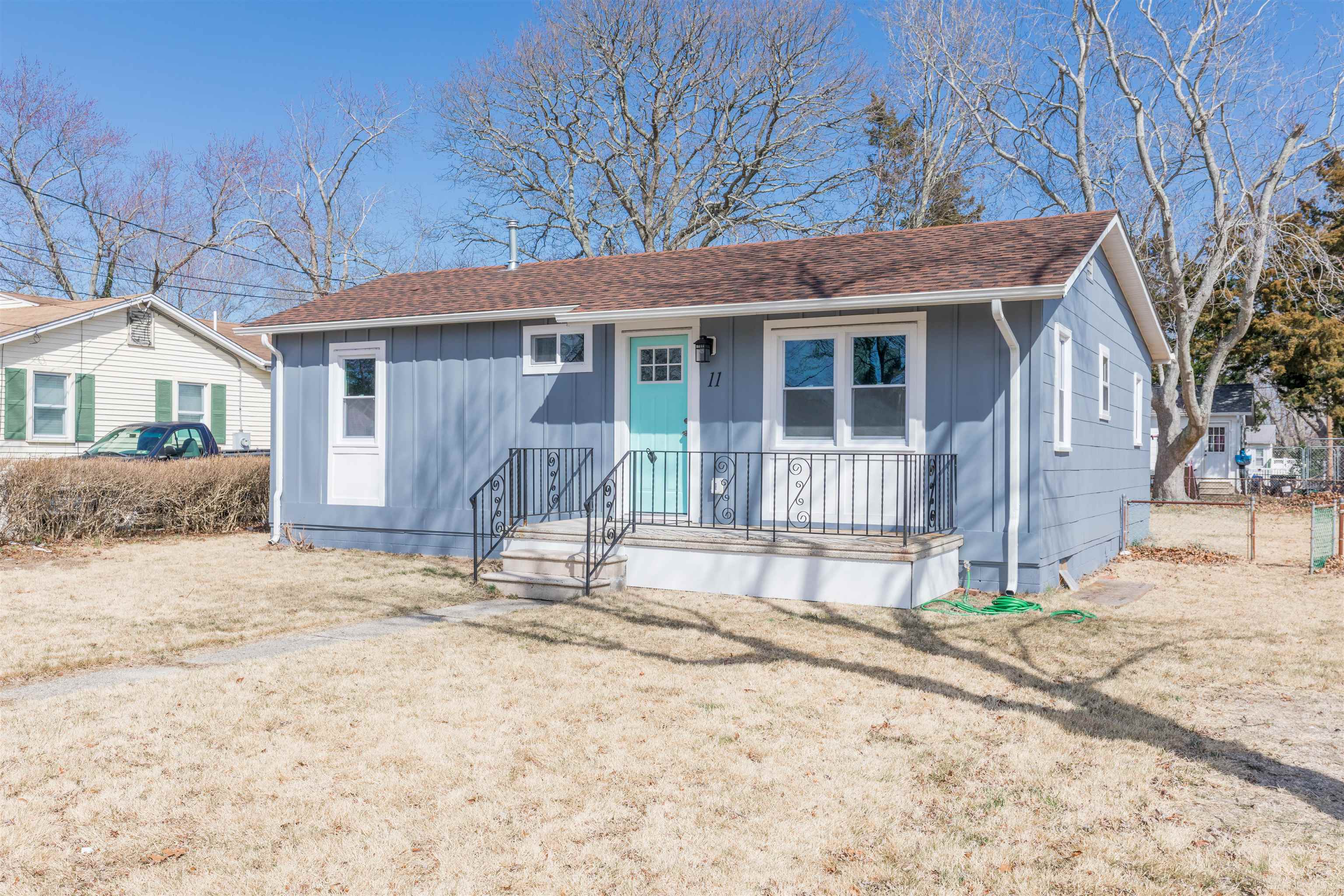 11 Vacation Road Villas, NJ 08251 - Photo 2 of 31 a front view of a house with a yard and potted plants