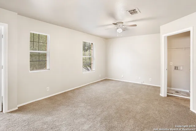 a view of a hallway with a ceiling fan