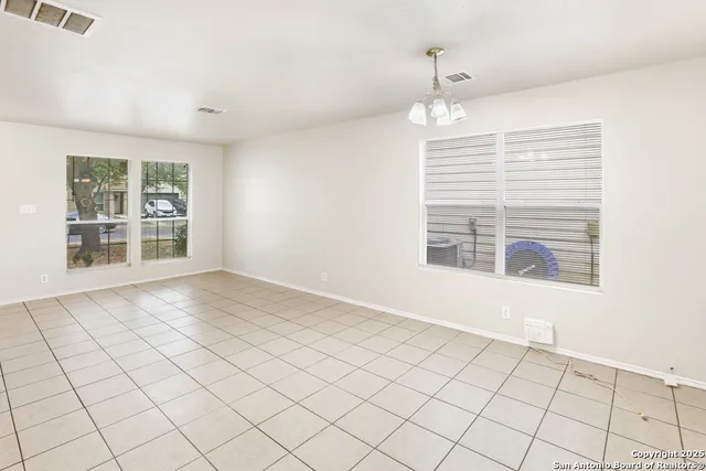 an empty room with windows and painted walls