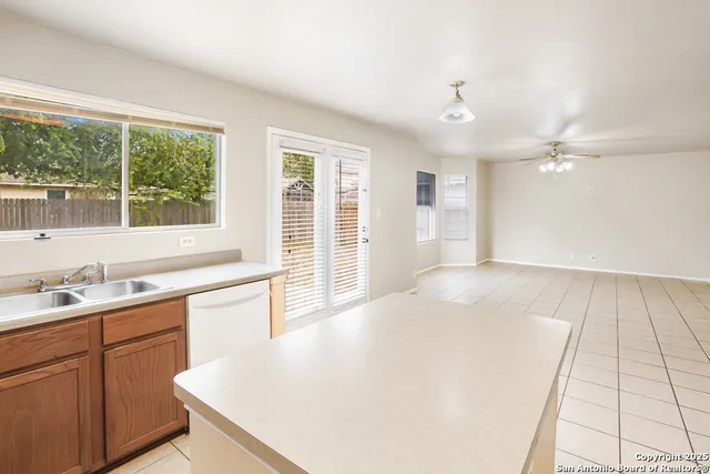 a kitchen with a sink a window and cabinets