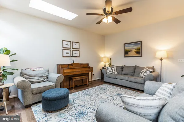 a living room with furniture a couch and a chandelier