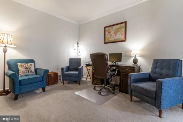 a livingroom with workspace couch and a couch
