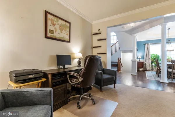 a livingroom with workspace and a couch