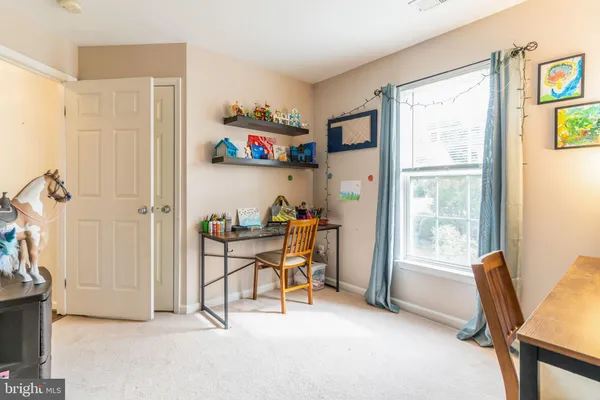 a view of a livingroom with furniture and a window