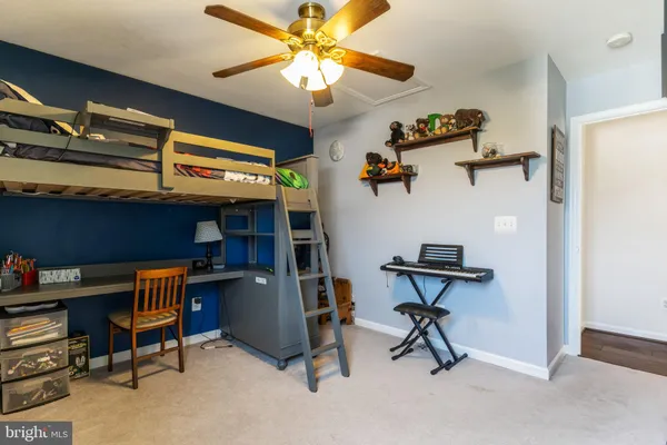 a workspace with furniture and fan