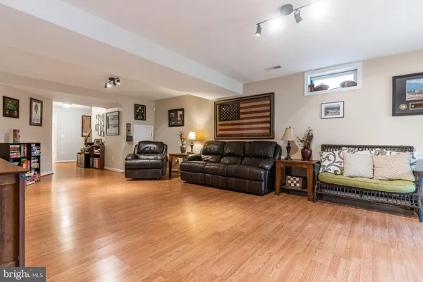 a living room with furniture and wooden floor