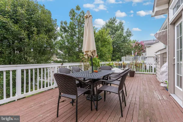 a view of a deck with furniture and wooden floor
