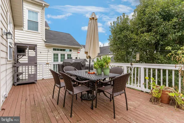 a view of a deck with furniture and wooden floor