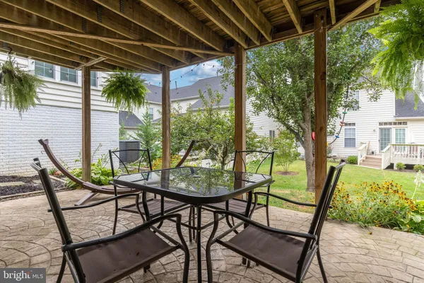 a view of a porch with furniture and wooden floor