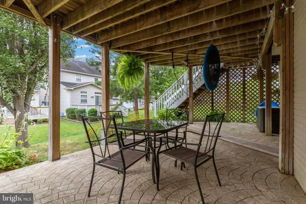a view of a patio with table and chairs and potted plants