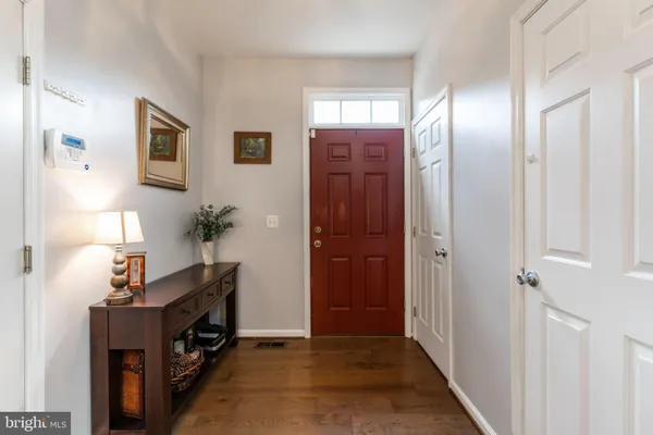 a view of a hallway with workspace and a window