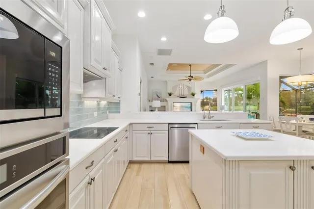 a view of a hallway with wooden floor and windows