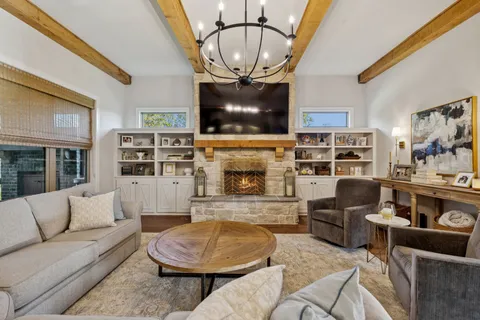 a kitchen with stainless steel appliances granite countertop a kitchen island hardwood floor and a sink