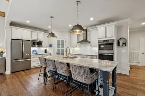 a dining room with a wooden table and chairs
