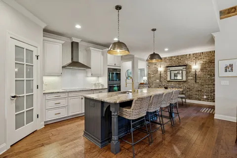 a kitchen with stainless steel appliances granite countertop a stove oven and a refrigerator