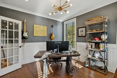 a bedroom with a bed and a chandelier