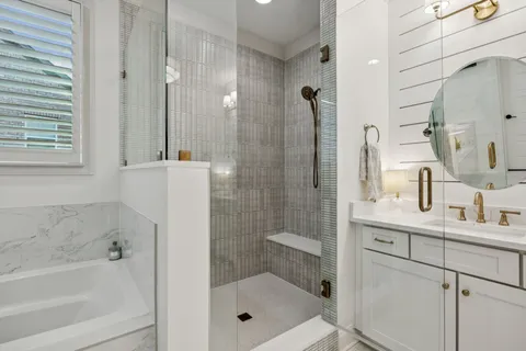 a spacious bathroom with a granite countertop sink a toilet a mirror and shower