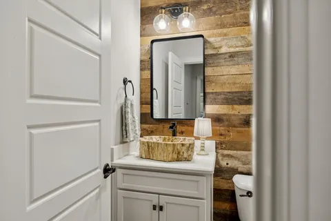 a bedroom with furniture and a rug