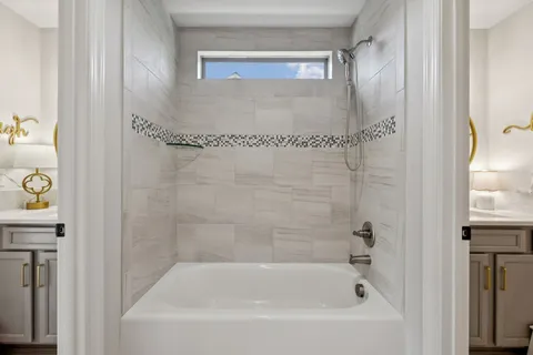 a bedroom with two beds and a window