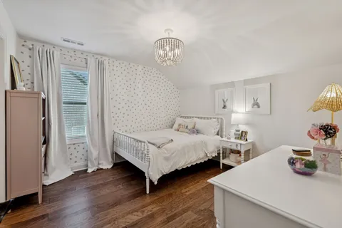 a bedroom with a bed and a desk