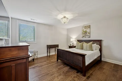 a bathroom with a granite countertop sink mirror vanity and toilet