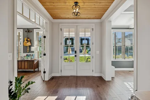 a view of entryway and hall with wooden floor