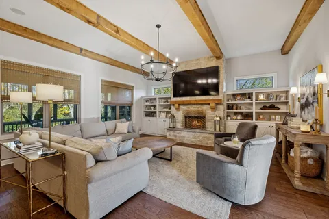 a living room with furniture a flat screen tv and a fireplace