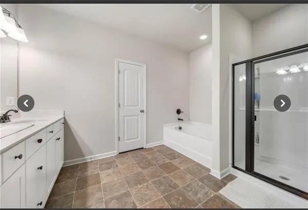a bathroom with a tub sink and shower