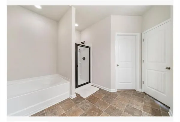 a bathroom with a bathtub and a shower