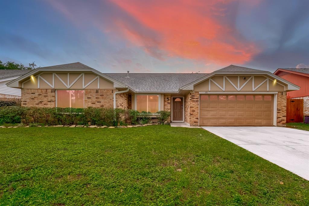 3811 Lemon Tree Lane Houston, TX 77088 - Photo 1 of 41 a front view of a house with a garden and yard