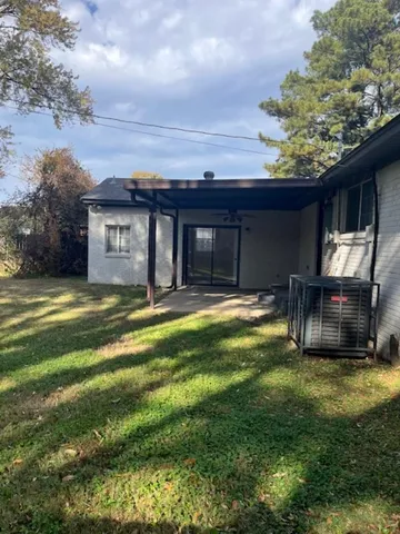 a house view with swimming pool in front of it