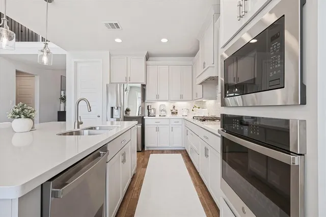 a kitchen with a sink stove and microwave