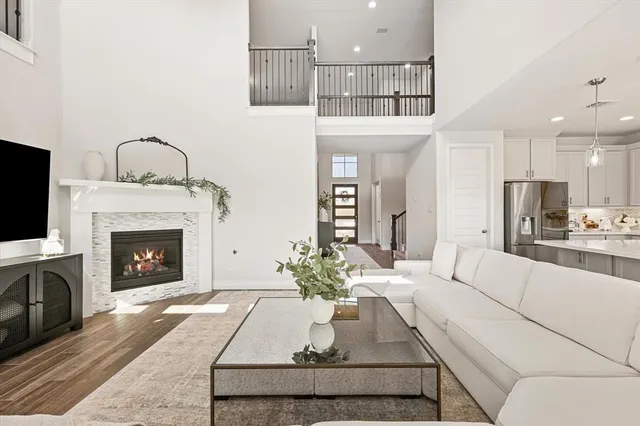 a living room with furniture a fireplace and a flat screen tv