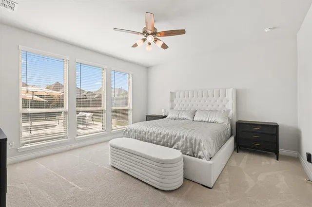 a spacious bedroom with a bed and a large window