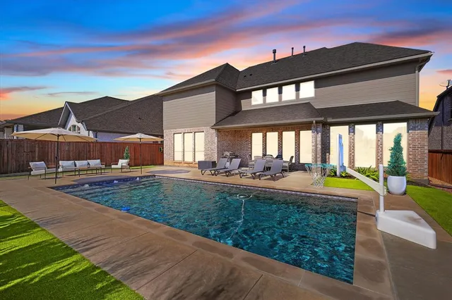 an aerial view of multiple houses with a yard